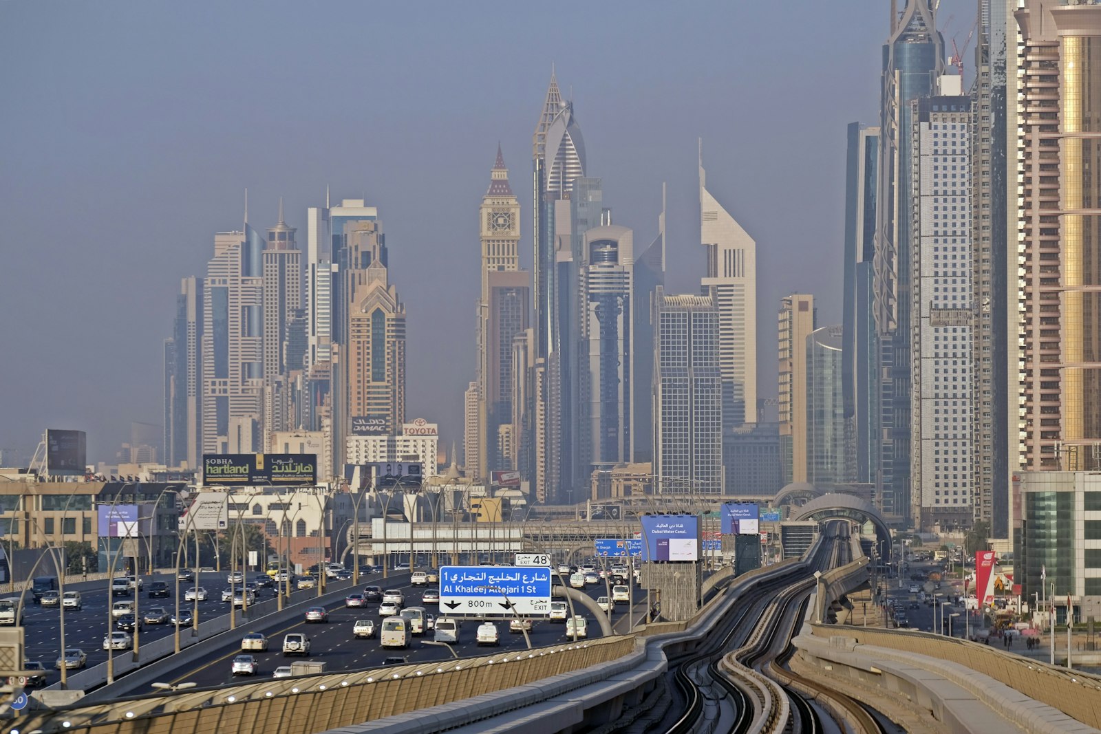 Dubai skyline seen from a metro carriage at dusk